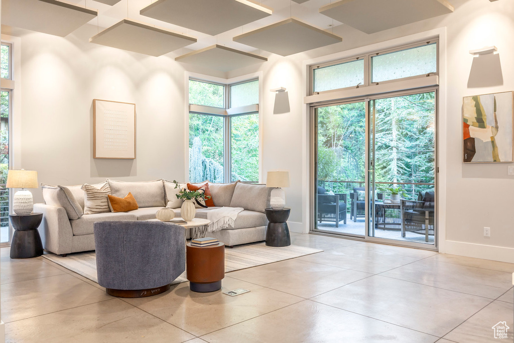 Tiled living room with baseboards and coffered ceiling