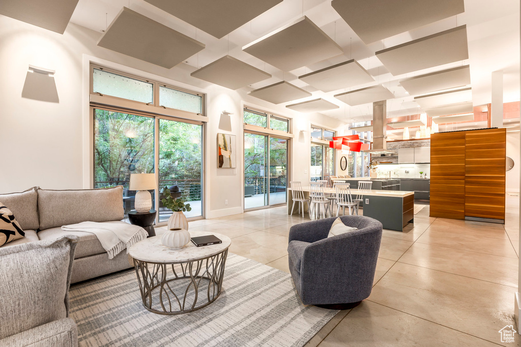 Living room featuring coffered ceiling and beam ceiling