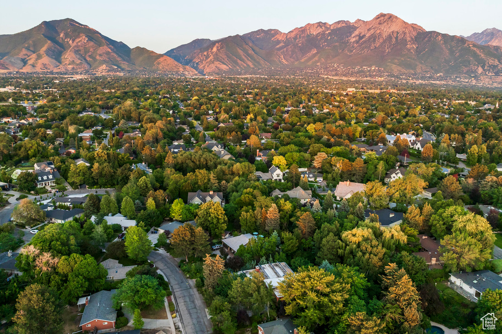 Aerial view of property and surrounding area with a mountain backdrop