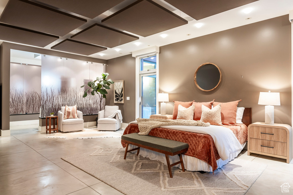 Bedroom with concrete flooring, coffered ceiling, and recessed lighting