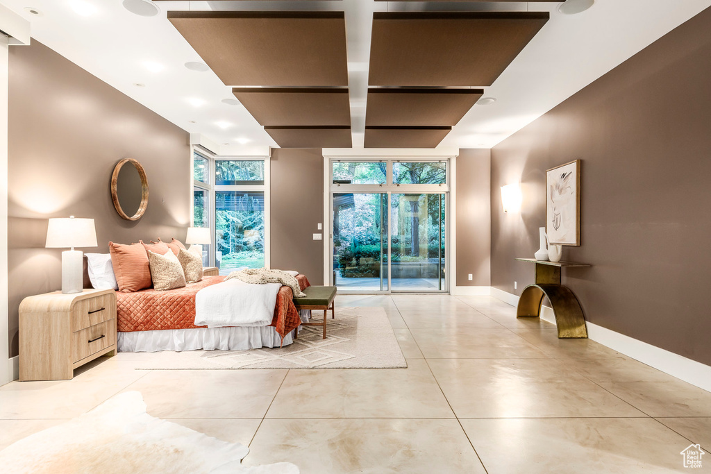 Bedroom with access to exterior and floor to ceiling windows