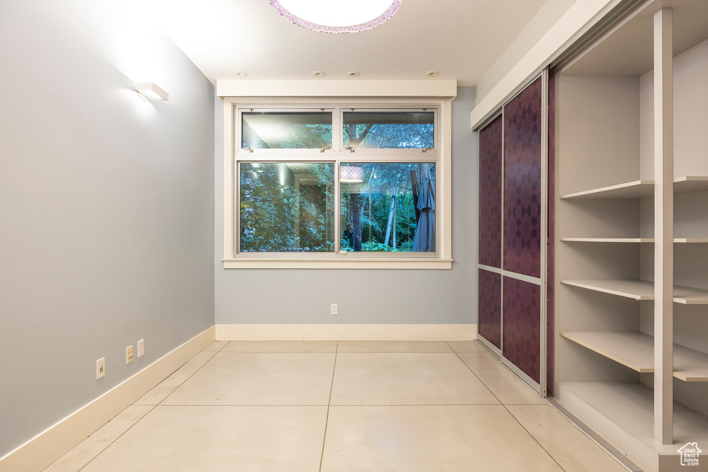 Interior space featuring tile patterned flooring and baseboards