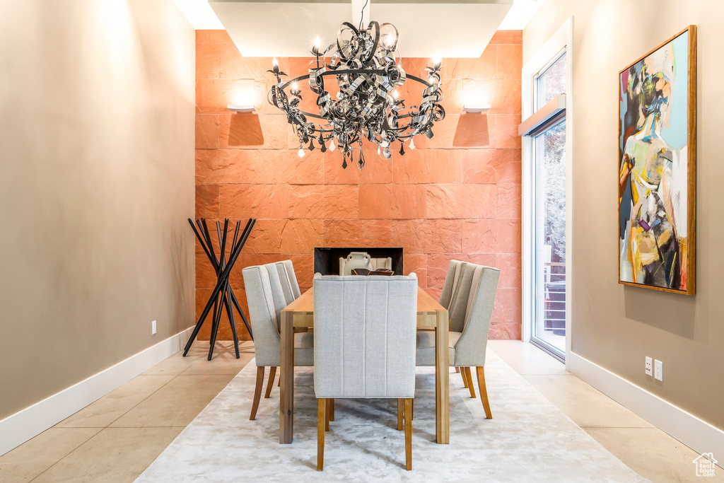 Dining space featuring a chandelier and tile patterned floors