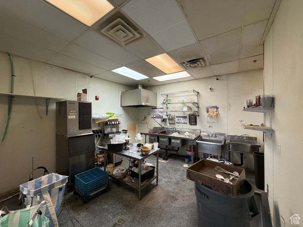 Misc room with a paneled ceiling and a workshop area