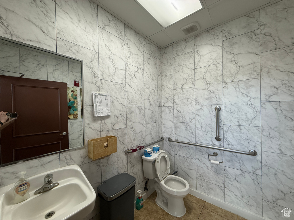 Half bathroom featuring a sink and tile patterned flooring