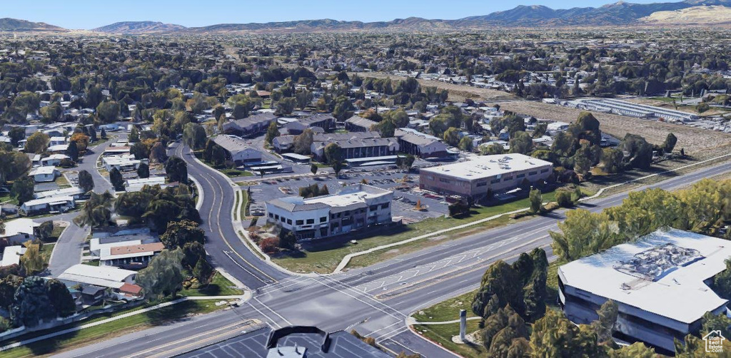 Aerial view of property's location featuring a mountain backdrop