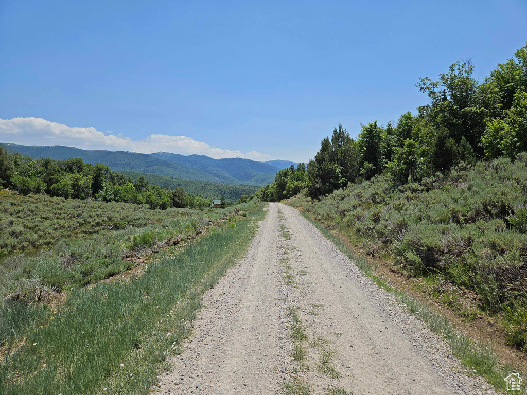 View of dirt / gravel road featuring a mountain view