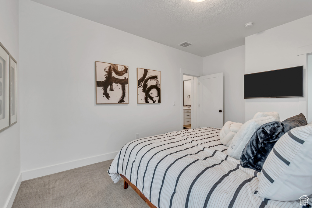 Carpeted bedroom featuring baseboards
