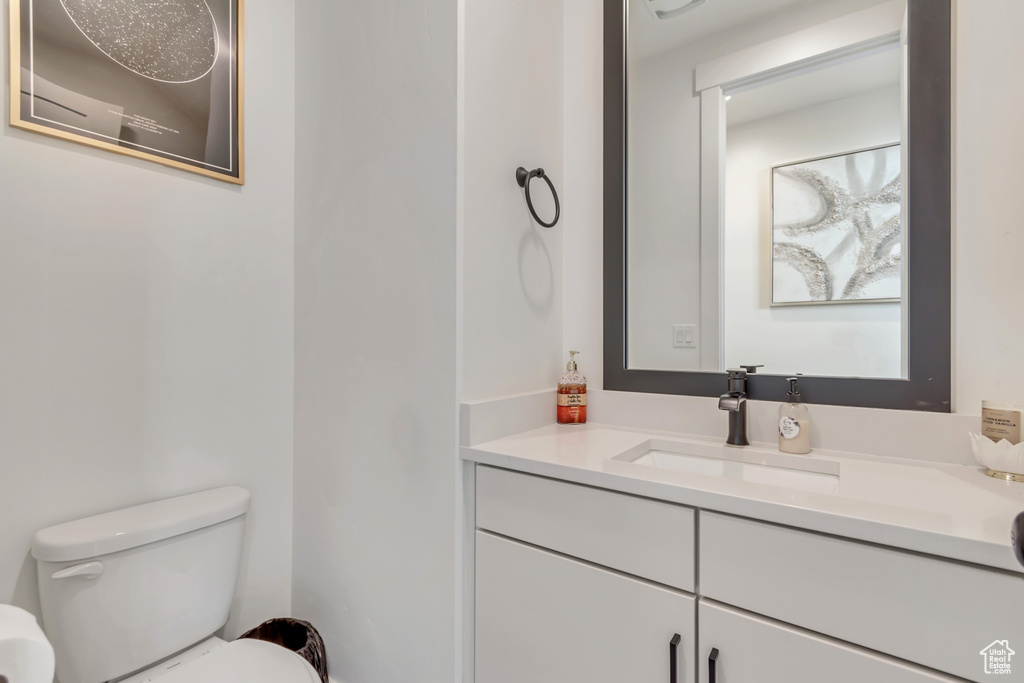 Half bathroom with toilet and vanity