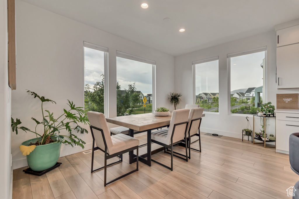 Dining space with recessed lighting and light wood finished floors