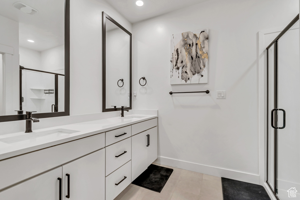 Full bath featuring double vanity, a stall shower, recessed lighting, and tile patterned floors