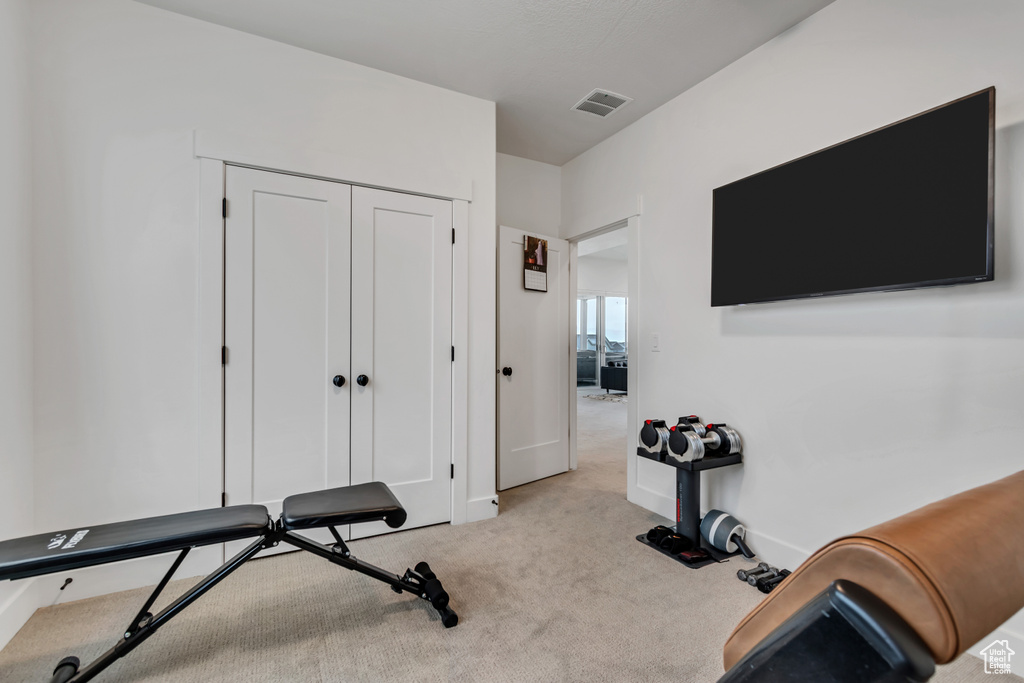 Workout room with carpet and baseboards