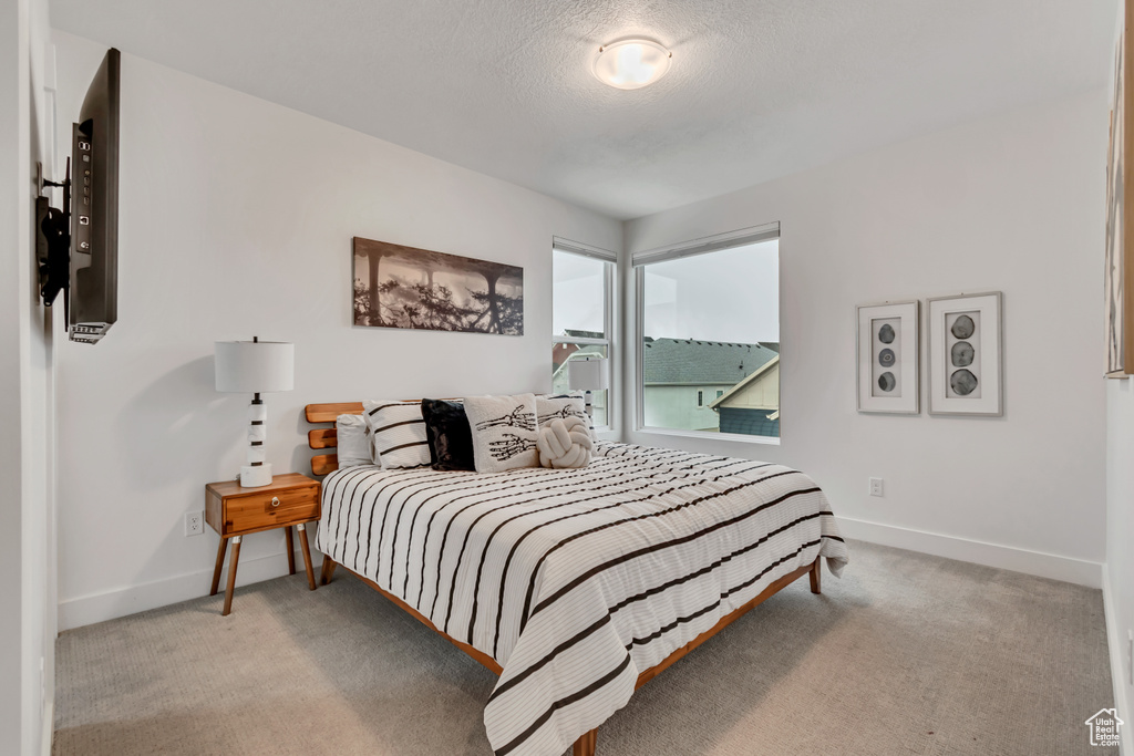 Carpeted bedroom with baseboards