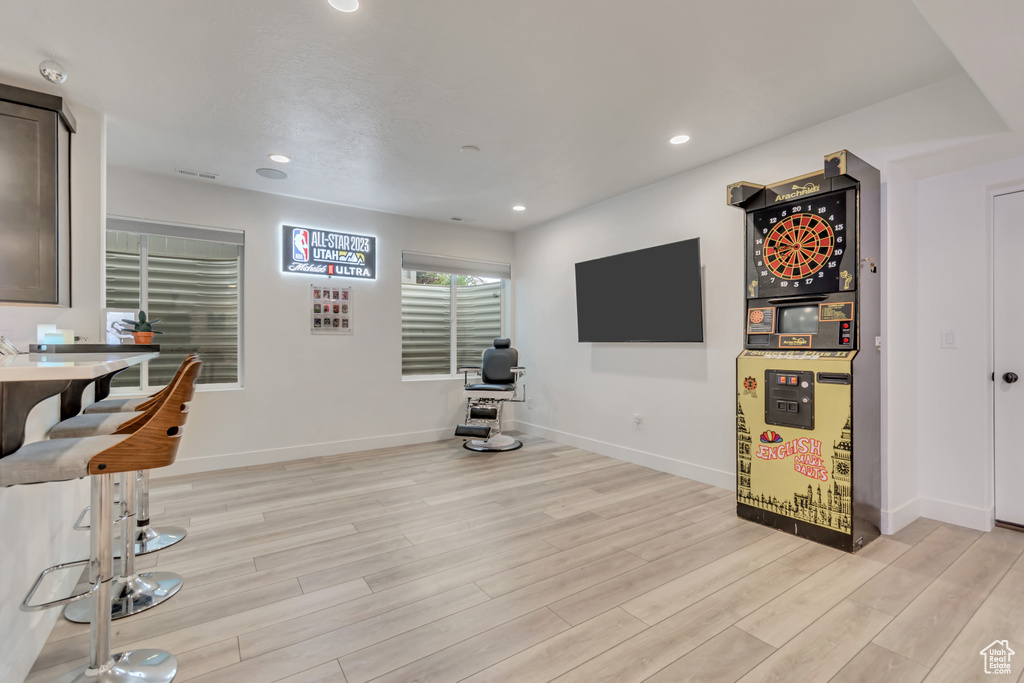 Living area featuring light wood finished floors and recessed lighting