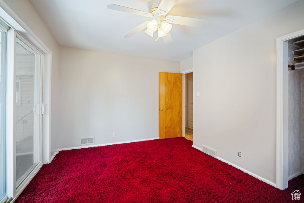 Unfurnished bedroom featuring carpet floors and a ceiling fan