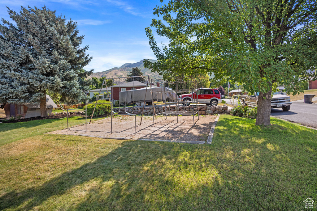 View of grassy yard with a mountain view