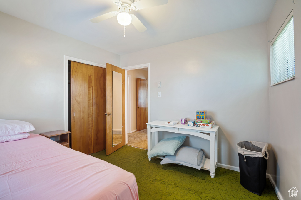Bedroom with carpet flooring, a ceiling fan, and a closet