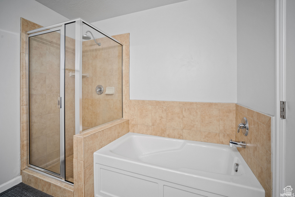 Bathroom with a garden tub and a stall shower
