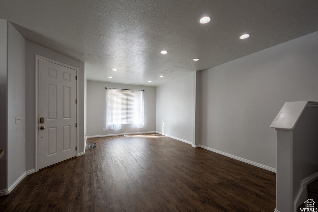 Spare room with dark wood finished floors, recessed lighting, and a textured ceiling