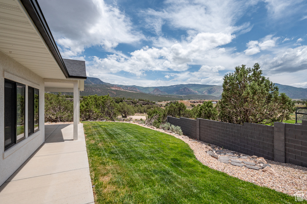View of yard featuring a mountain view and a patio
