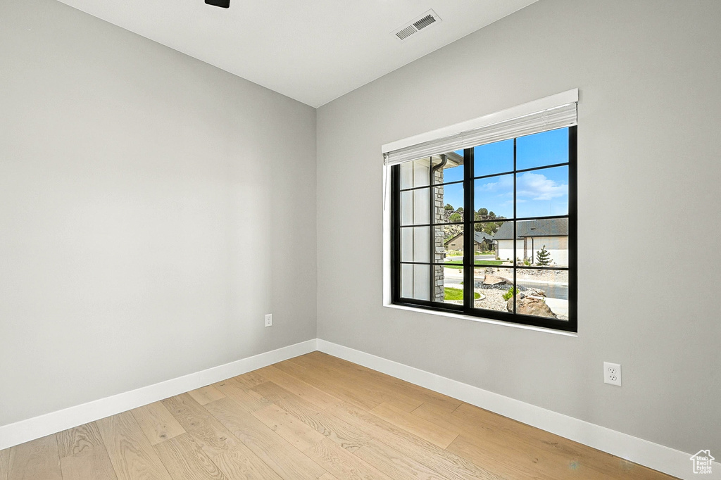 Unfurnished room with baseboards and light wood-type flooring