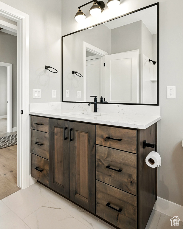Bathroom with vanity and baseboards