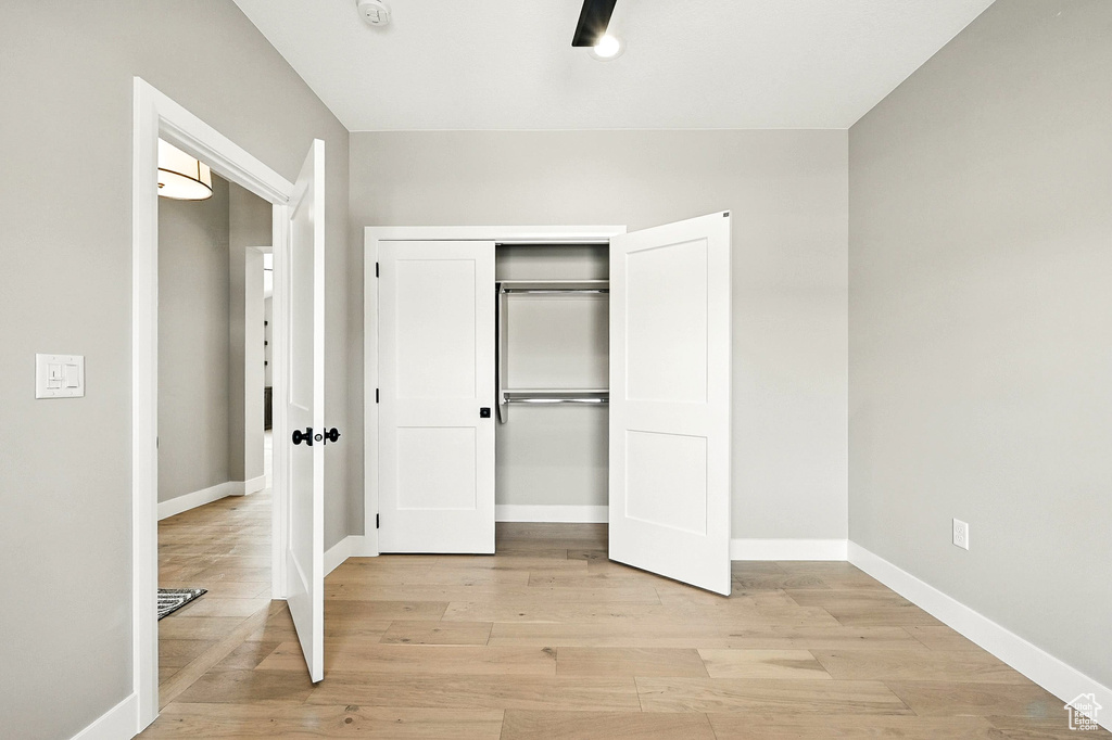 Unfurnished bedroom featuring light wood-style floors and a closet