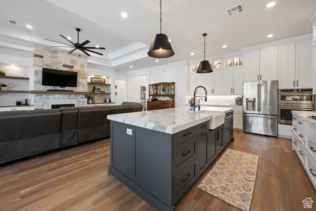 Kitchen with appliances with stainless steel finishes, white cabinets, gray cabinetry, a ceiling fan, and recessed lighting
