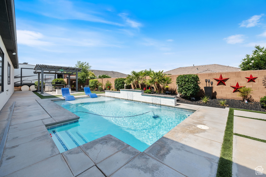 View of pool featuring a pergola, a patio area, and a fenced backyard