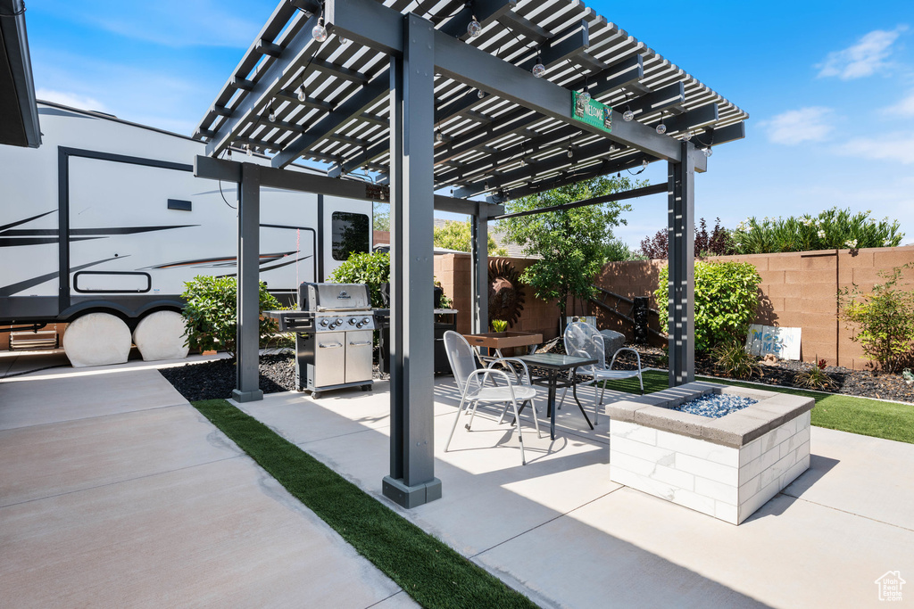 Fenced backyard with an outdoor fire pit, grilling area, a patio area, and a pergola