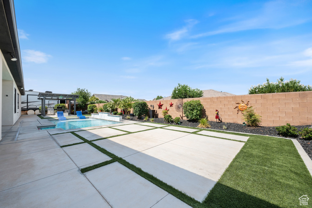 View of pool featuring a pergola, a fenced backyard, and a patio area