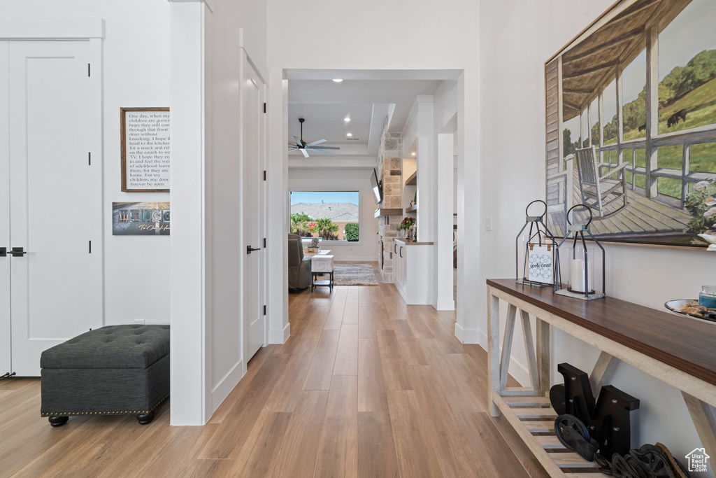 Corridor featuring light wood-type flooring and recessed lighting