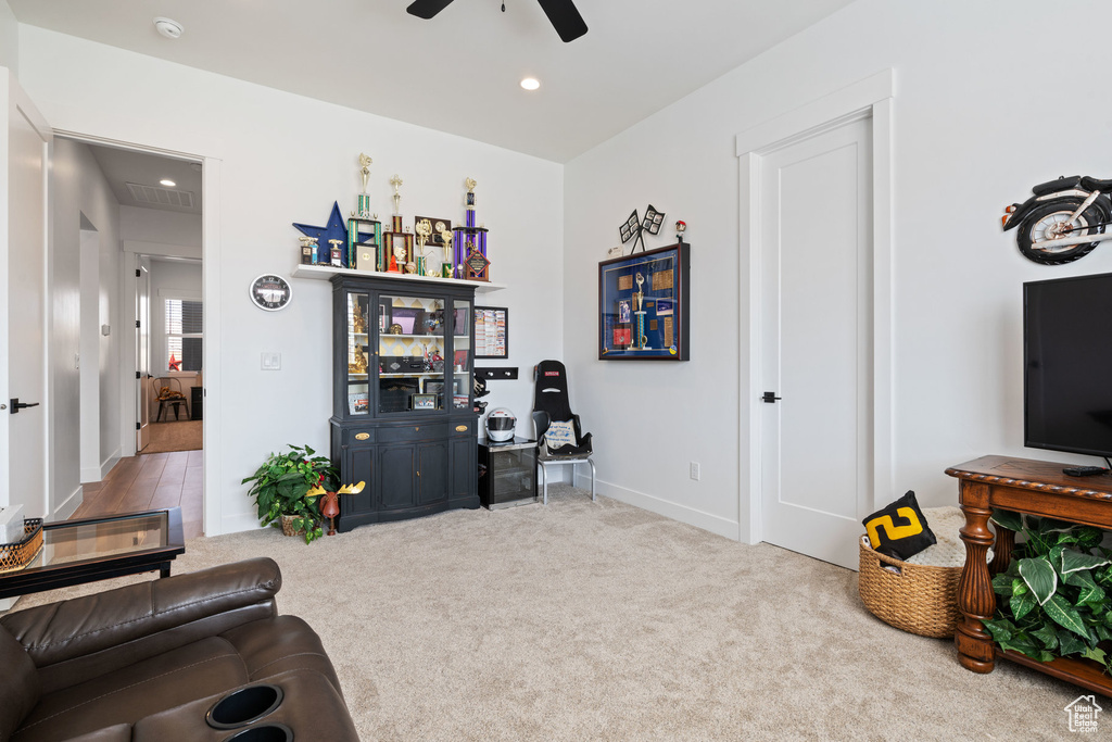 Living room featuring ceiling fan, carpet floors, and recessed lighting