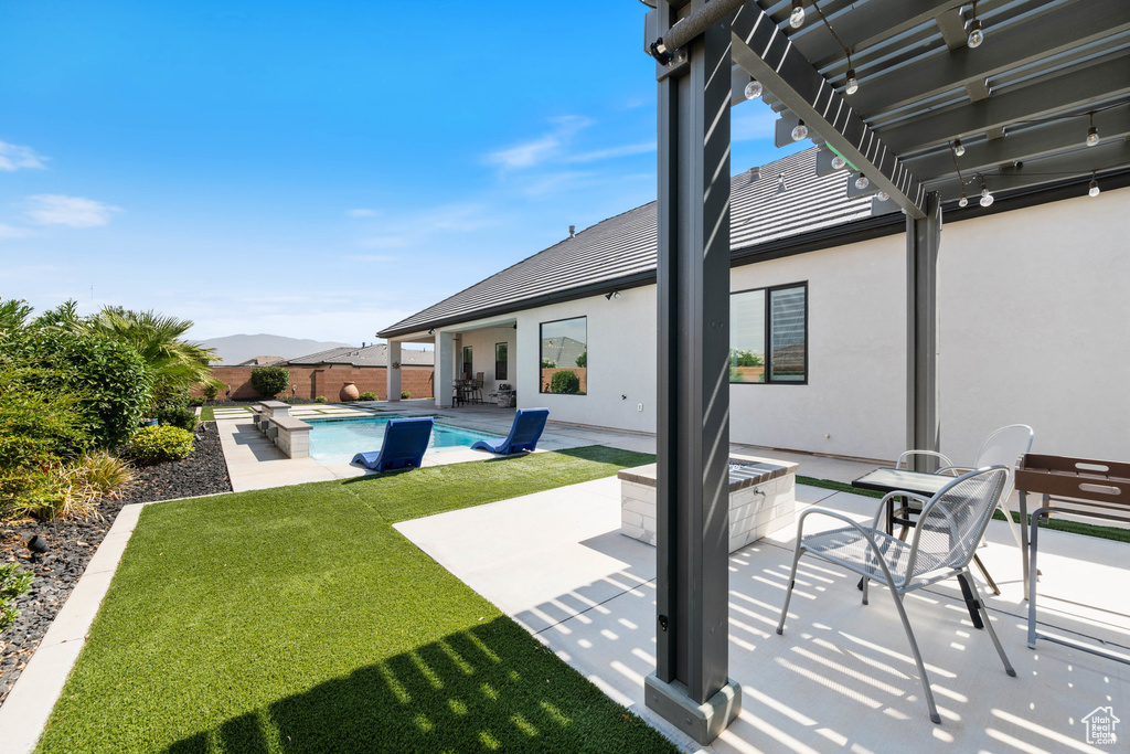 Fenced backyard with a pergola, a hot tub, and a patio area