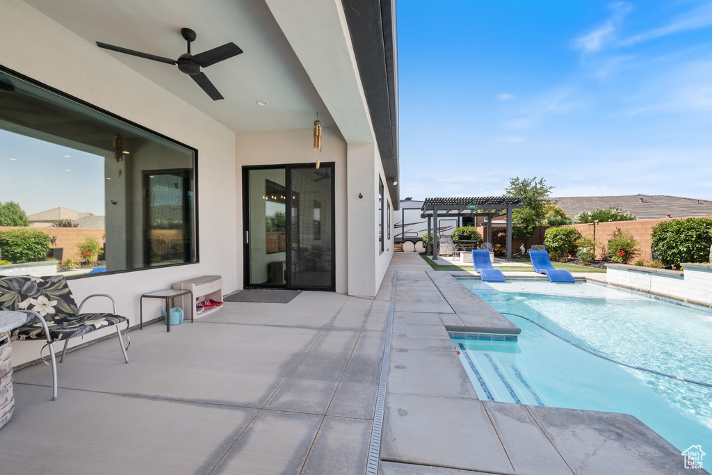 View of pool featuring a pergola, a patio area, and a ceiling fan