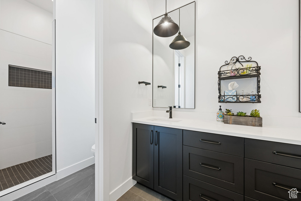 Full bathroom featuring tiled shower and vanity