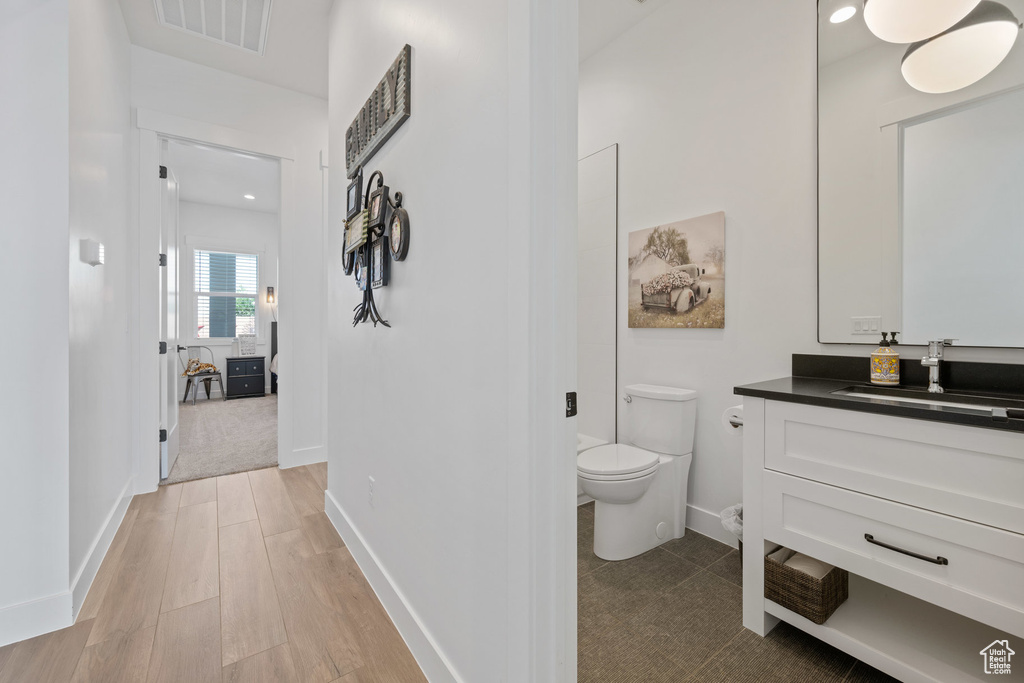 Bathroom featuring vanity and wood finished floors