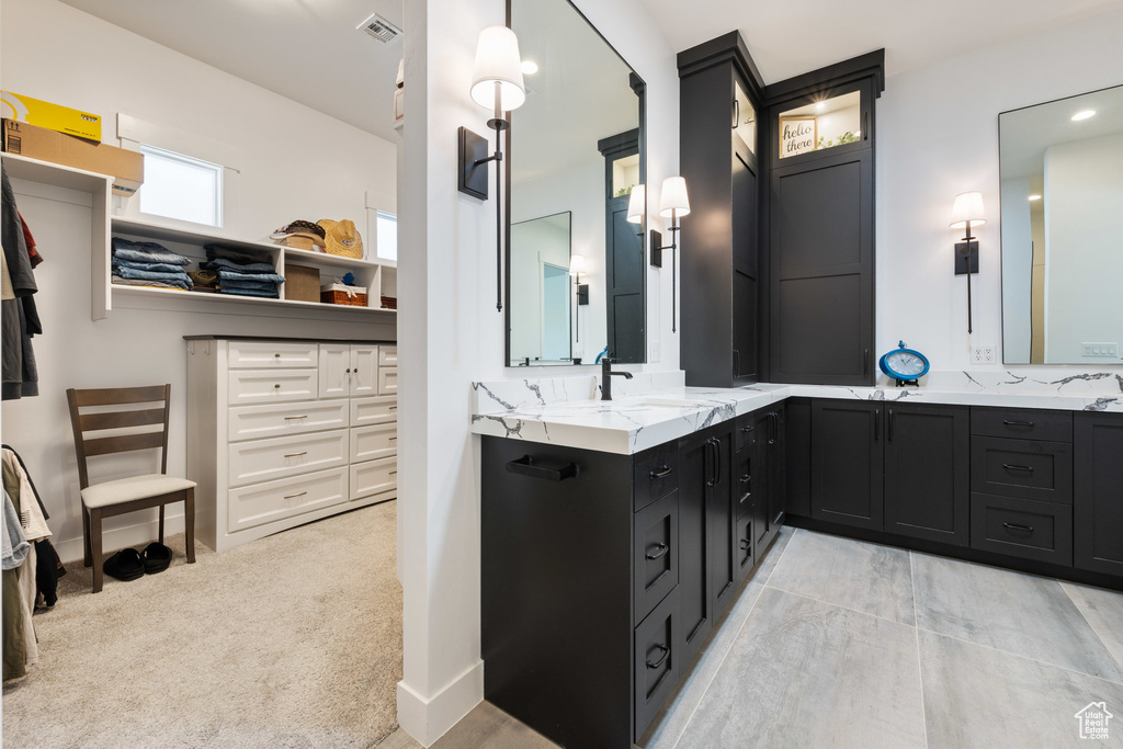 Bathroom with double vanity and a closet