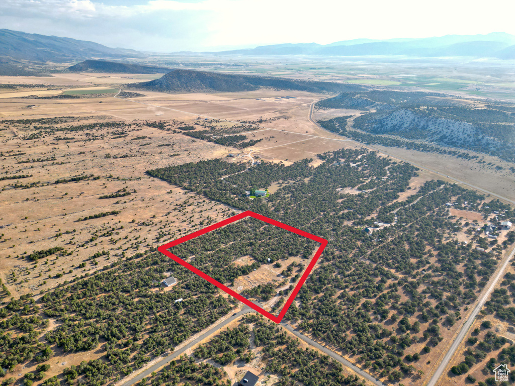 Overview of rural landscape with a mountain backdrop and property parcel outlined