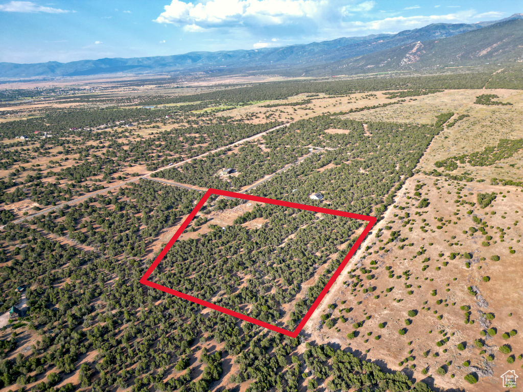 Aerial view of sparsely populated area with a mountain backdrop and property boundaries highlighted