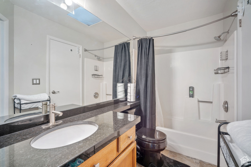 Bathroom featuring shower / tub combo with curtain and vanity
