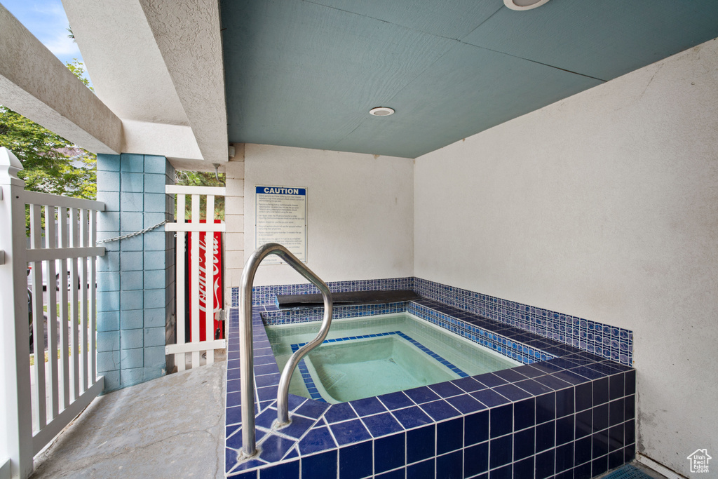 View of pool with an in-ground hot tub