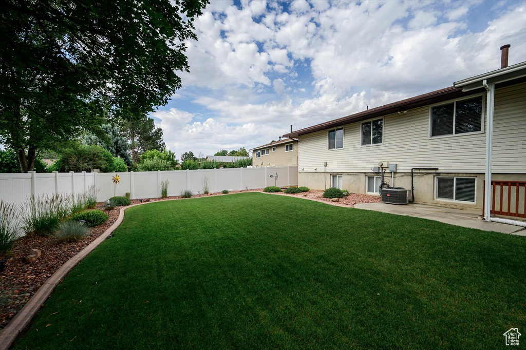 Fenced backyard with a patio