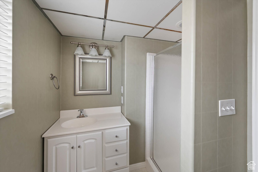 Full bathroom featuring a stall shower and vanity