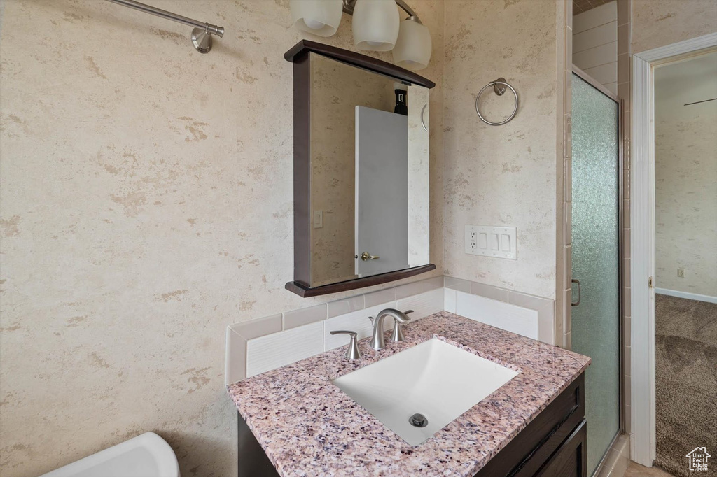 Bathroom featuring vanity and a shower stall