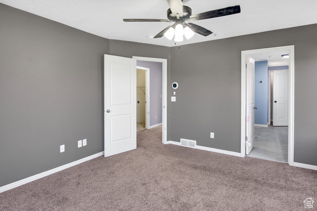 Unfurnished bedroom with carpet and a ceiling fan