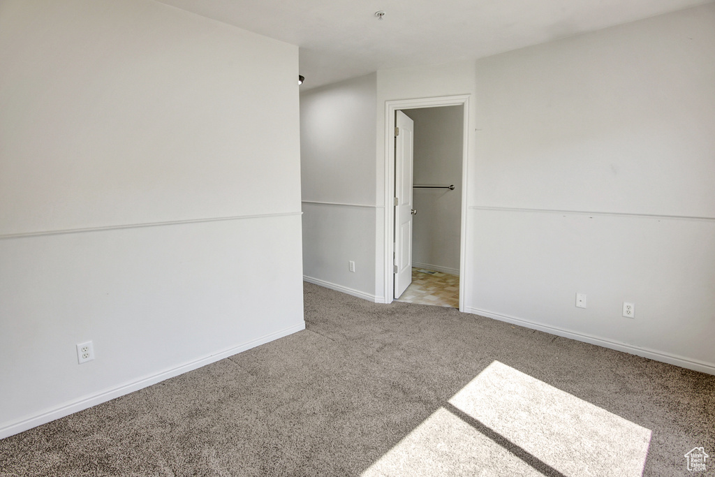 Unfurnished bedroom featuring carpet and baseboards