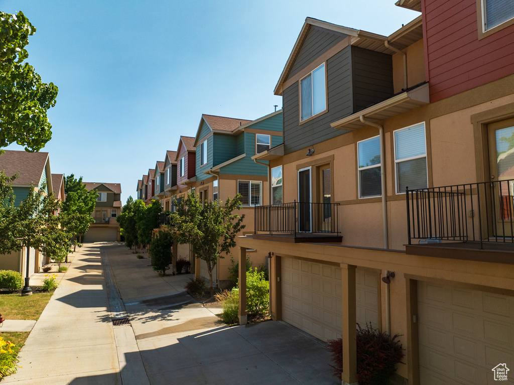 Surrounding community with a residential view, a garage, and driveway