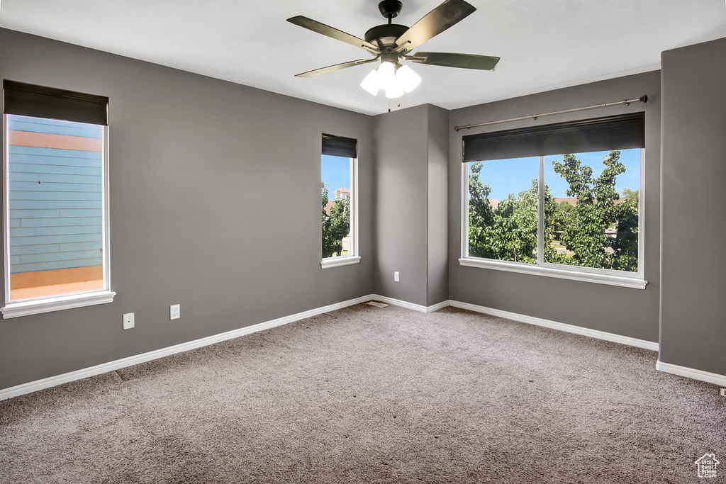 Empty room with carpet and ceiling fan