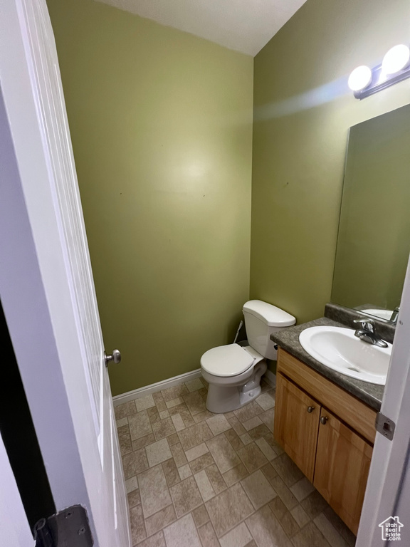 Half bath featuring vanity and toilet